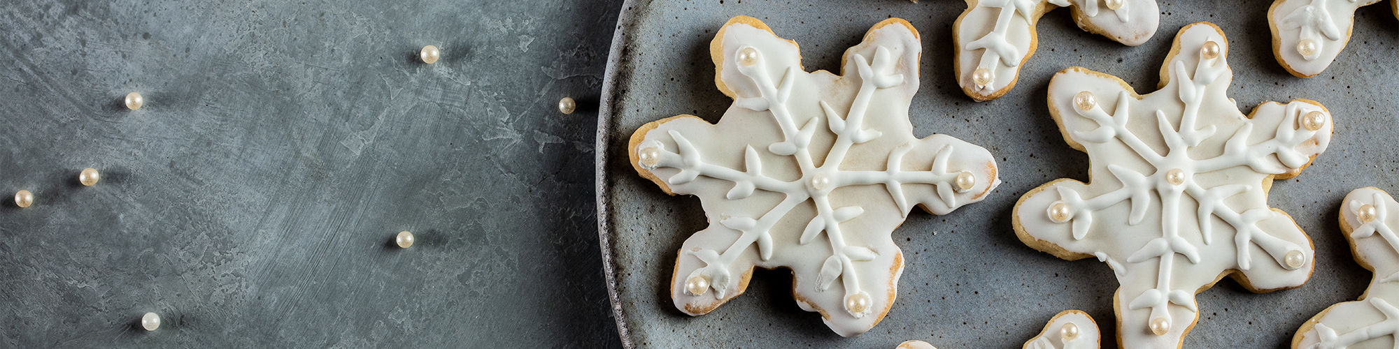 snowflake sugar cookie decorateed with domino sugar royal icing