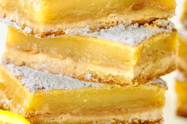 lemon bars made with domino golden sugar and light brown sugar, topped powdered sugar 
