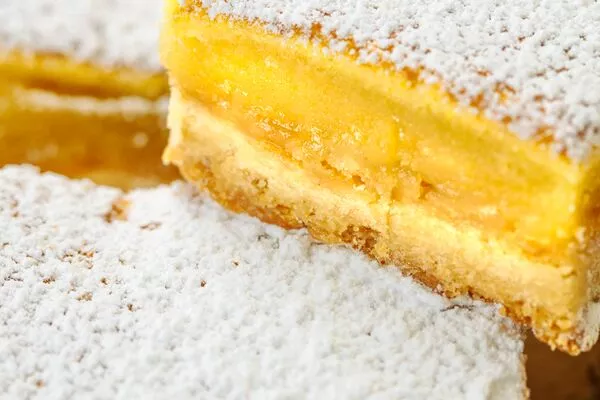 lemon bars made with domino golden sugar and light brown sugar, topped powdered sugar 