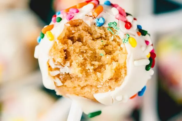 bite of no bake birthday cake pop made with domino dark brown sugar and powdered sugar