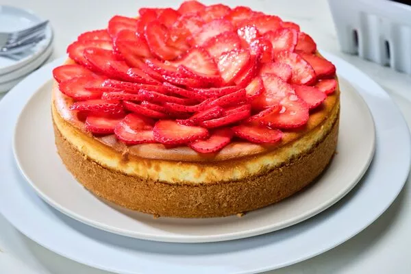 domino golden sugar cheesecake topped with fresh strawberries